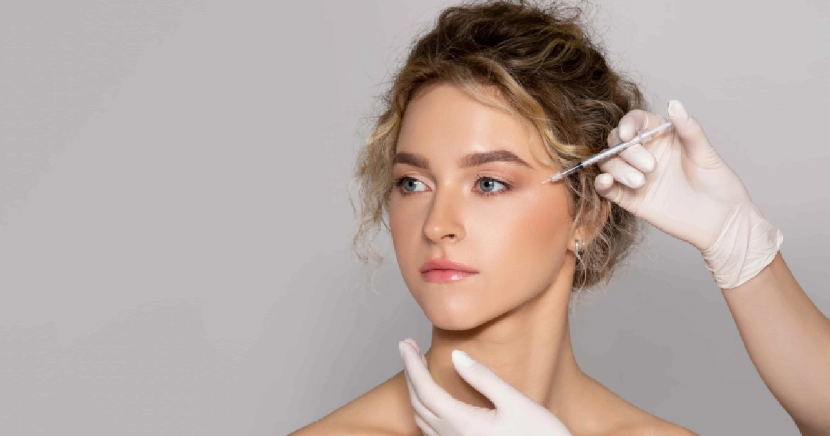 Woman receiving Botox injection near eye area for wrinkle reduction, performed by a medical professional wearing gloves in Henderson, NV